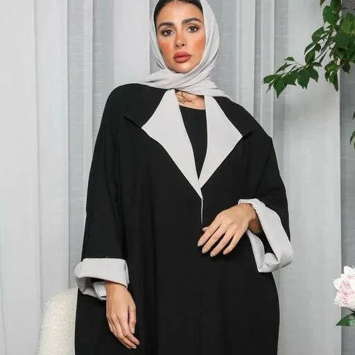 Woman wearing a freesize blazer abaya in black and grey crepe fabric with a relaxed fit and modern style