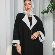 Woman wearing a freesize blazer abaya in black and grey crepe fabric with a relaxed fit and modern style