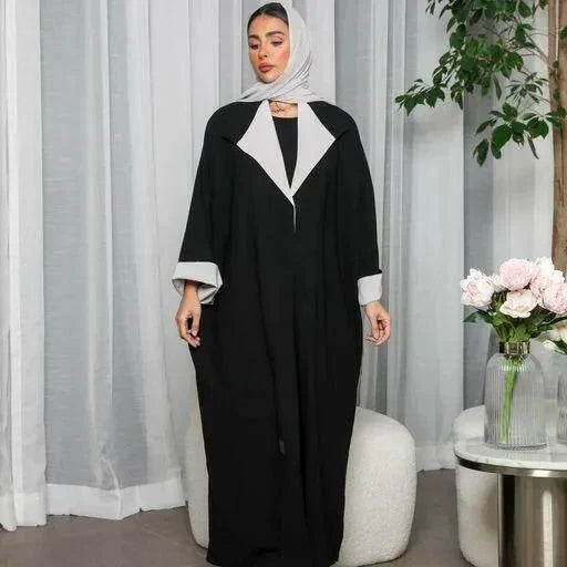 Woman wearing a freesize blazer abaya in black and grey crepe fabric with a relaxed fit and modern style