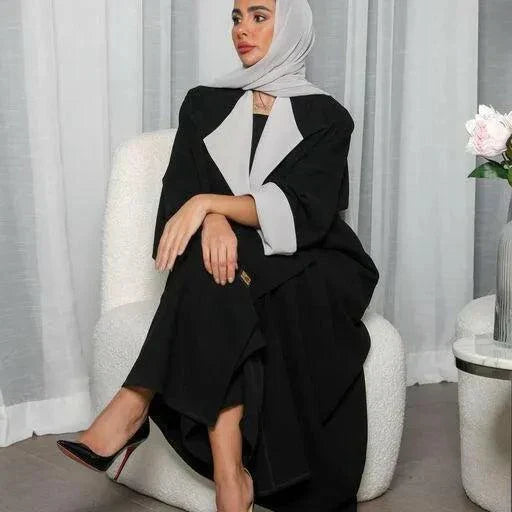 Woman wearing a freesize blazer abaya in black and grey crepe fabric with a relaxed fit and modern style