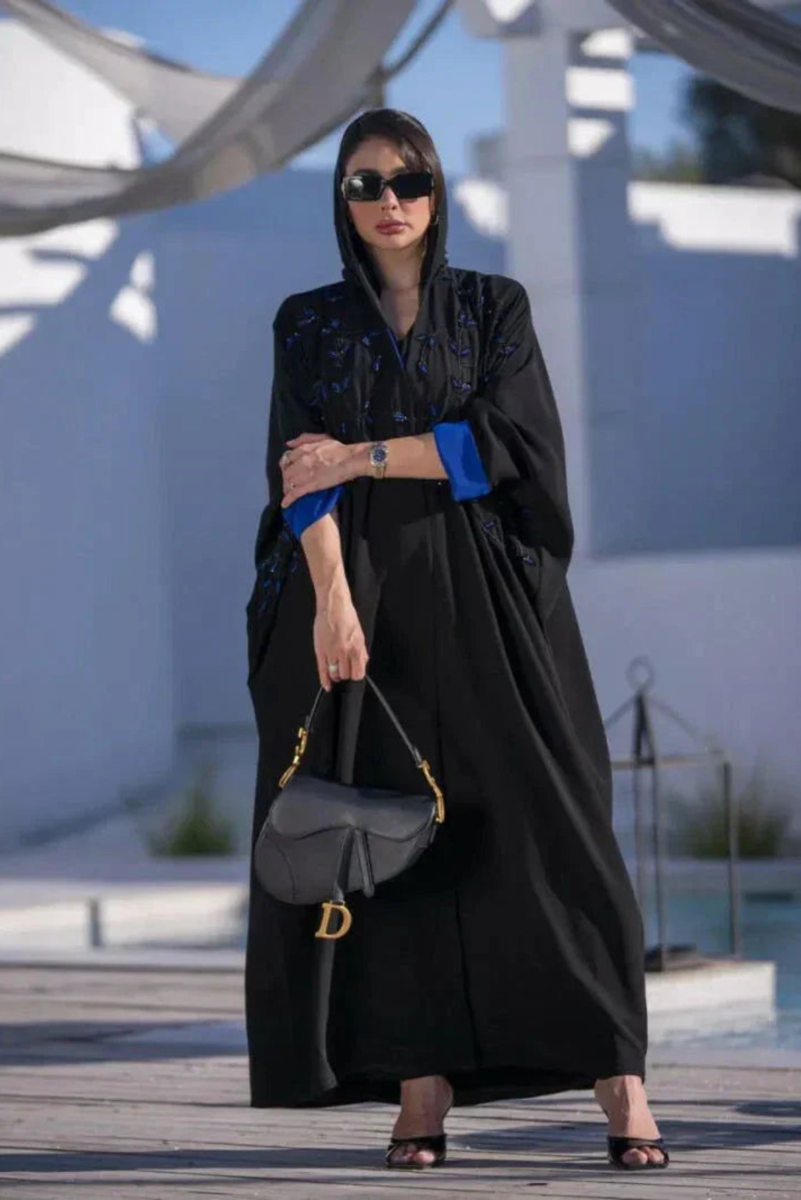 Flowy black abaya with blue embroidery and wide sleeves, featuring blue inner lining and matching sheila.