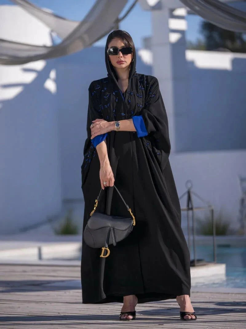 Black flowy abaya with blue embroidery and inner blue lining, paired with a matching sheila for formal evening wear.