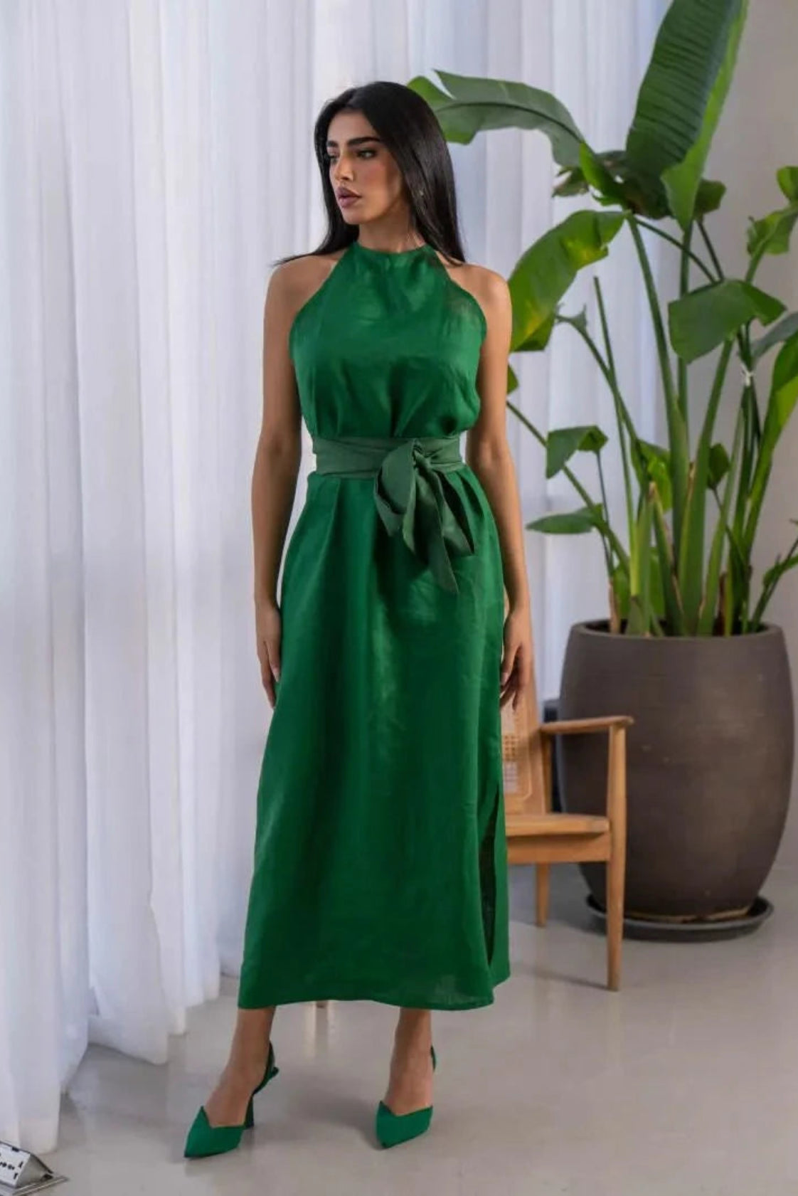 Green sleeveless linen midi dress with halter neckline and wide waist tie