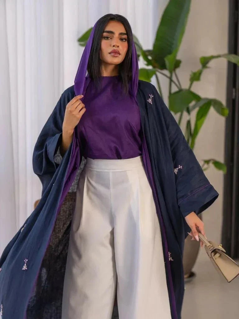 Mystic navy blue linen bisht with purple lines and hand-stitched accents styled with a purple blouse and white pants.