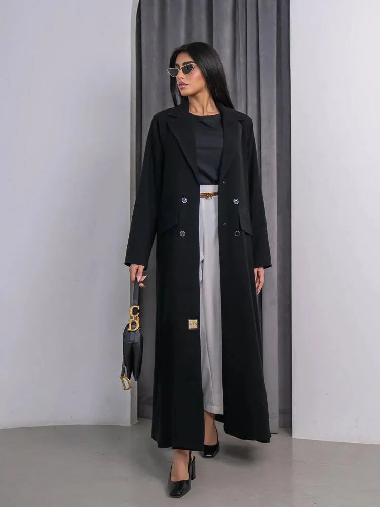 Black Clara blazer-style abaya with notched lapel, double-breasted buttons, and long sleeves in sleek crepe fabric.