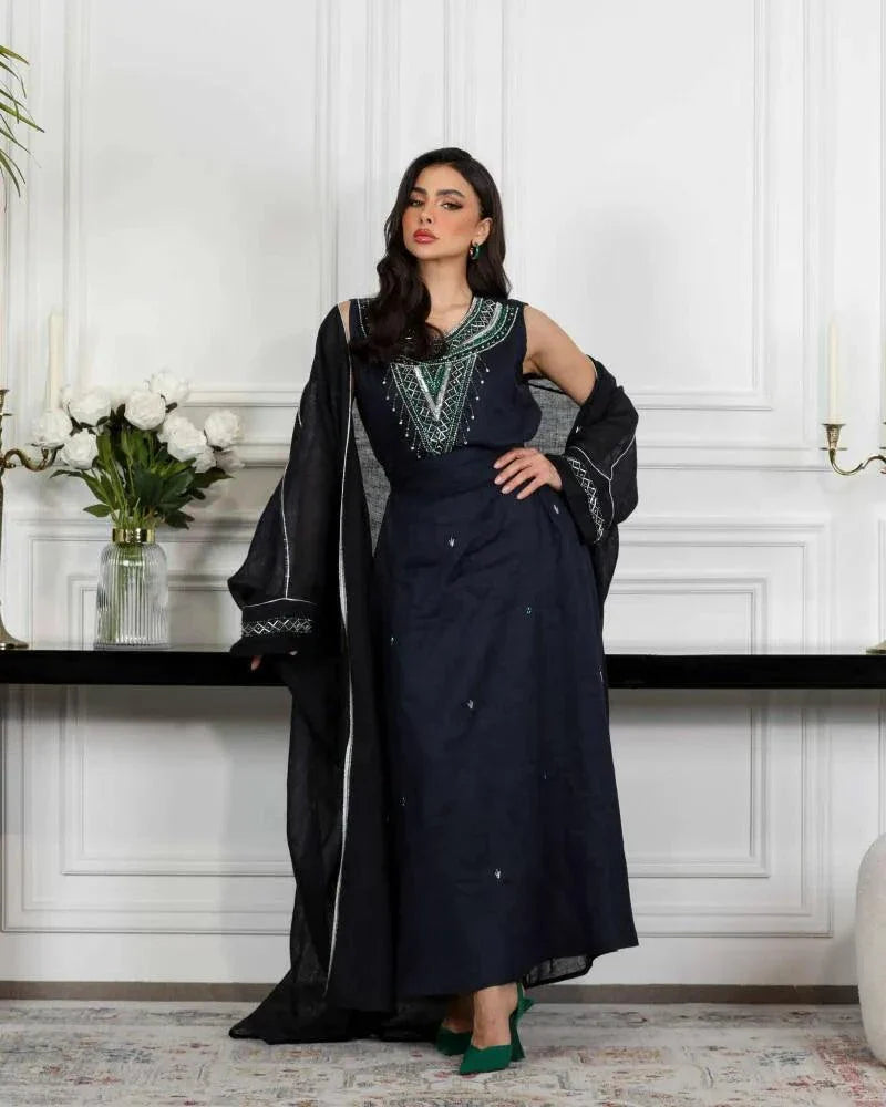 Navy blue linen three-piece set with sleeveless embroidered top, high-waisted skirt, and matching outer layer with green and silver threadwork called Midnight Vine