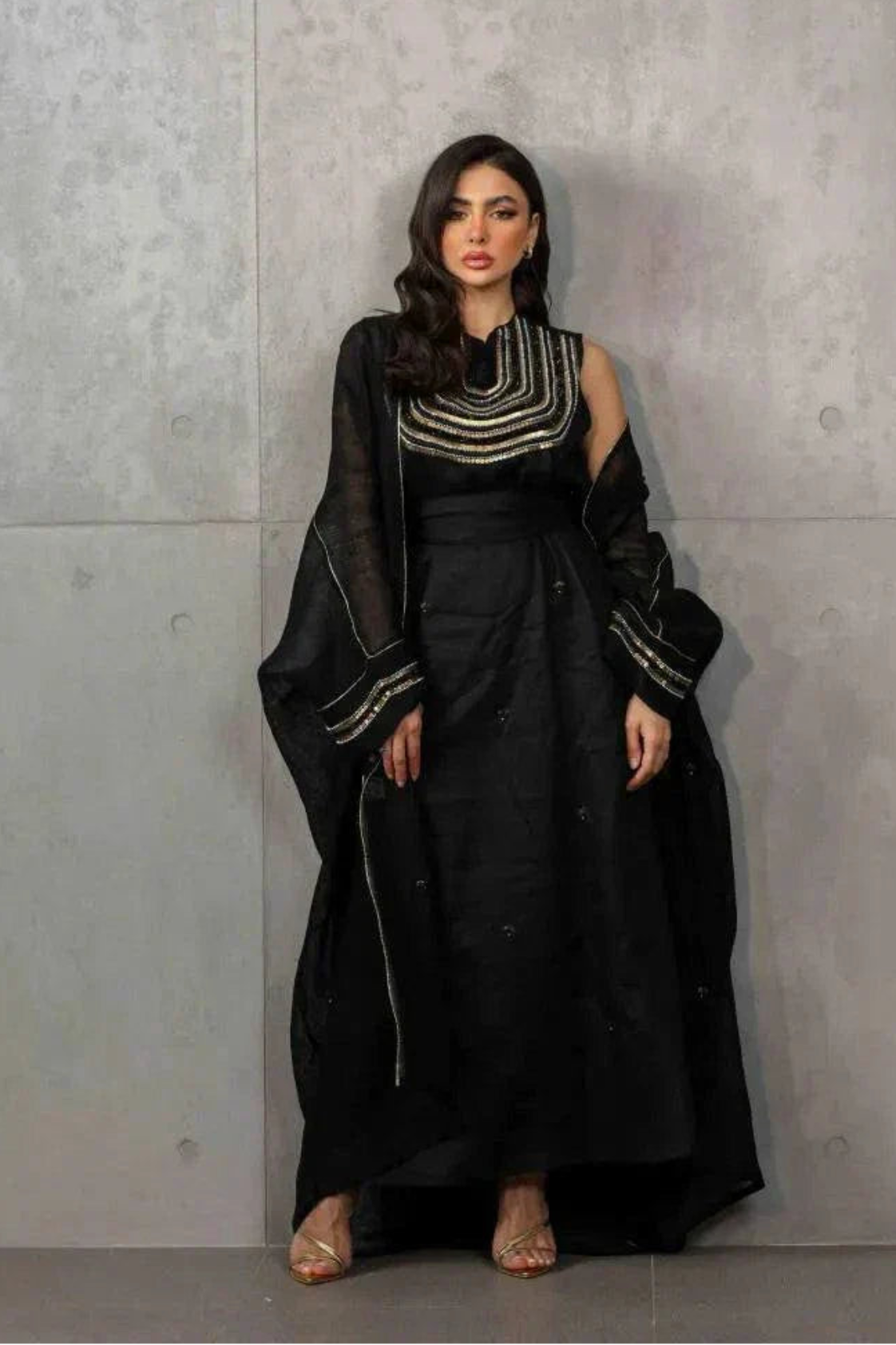 Elegant three-piece black linen set with sleeveless embroidered top, flowy skirt, and matching shawl.