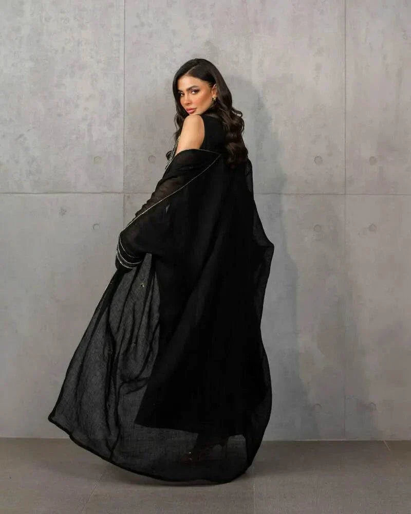 Elegant three-piece black linen set with sleeveless embroidered top, flowy skirt, and matching shawl.