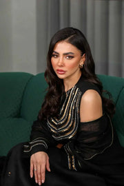 Elegant three-piece black linen set with sleeveless embroidered top, flowy skirt, and matching shawl.