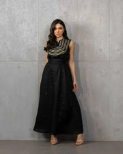 Elegant three-piece black linen set with sleeveless embroidered top, flowy skirt, and matching shawl.