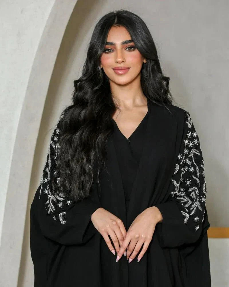 Black crepe abaya with silver nature-inspired embroidery on sleeves and V-neckline