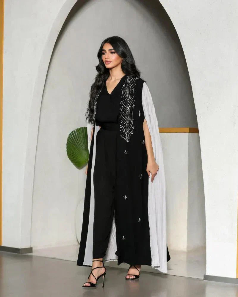 black crepe abaya with white pleated side panels and silver bead embroidery in a leaf pattern