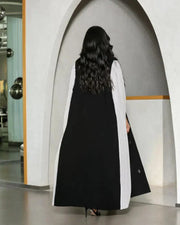 black crepe abaya with white pleated side panels and silver bead embroidery in a leaf pattern