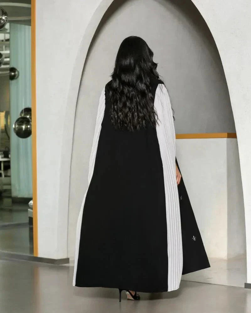 black crepe abaya with white pleated side panels and silver bead embroidery in a leaf pattern