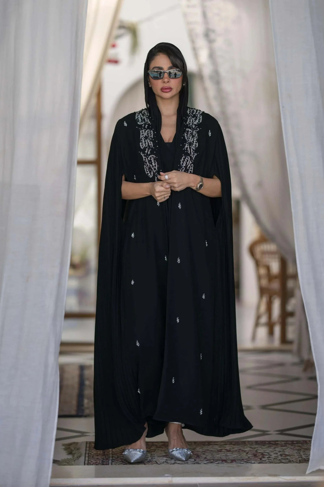 Elegant black abaya with silver embroidery and pleated cape sleeves for special occasions