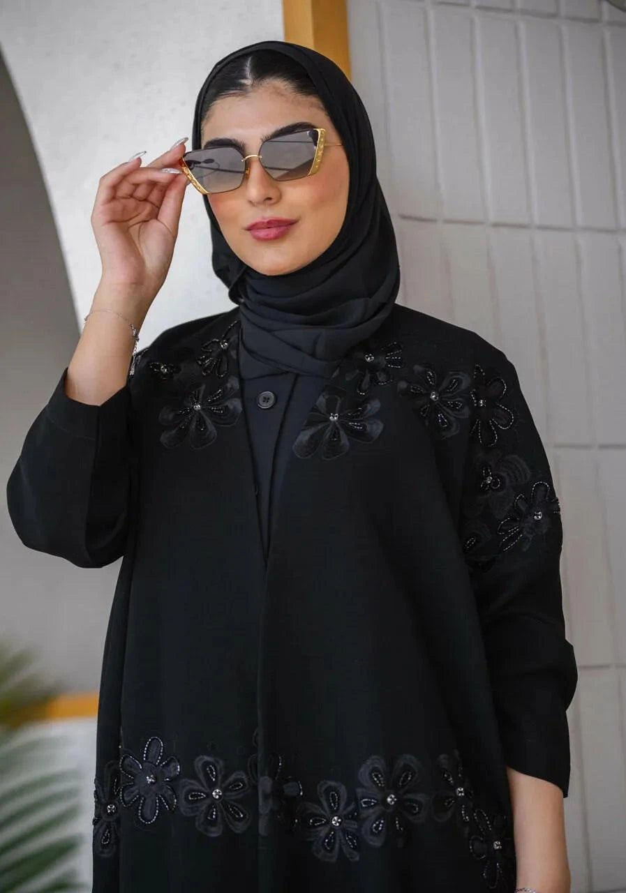 Elegant black crepe abaya with delicate embroidery and lace details featuring a subtle rose pattern, styled for refined elegance - Elegant Abaya