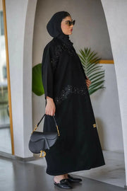 Elegant black crepe abaya with delicate embroidery and lace details featuring a subtle rose pattern, styled for refined elegance - Elegant Abaya
