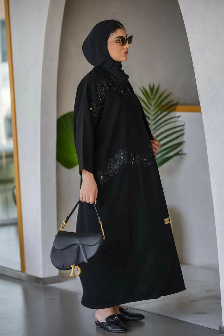Elegant black crepe abaya with delicate embroidery and lace details featuring a subtle rose pattern, styled for refined elegance - Elegant Abaya