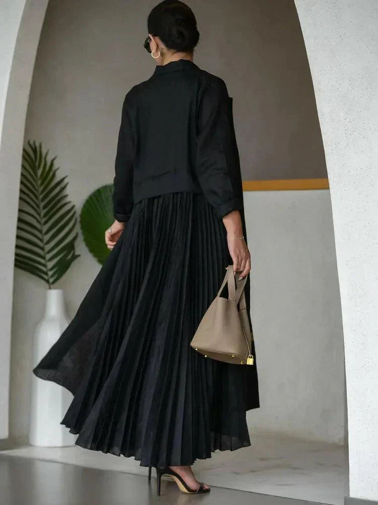 woman wearing elegant black linen abaya with structured collar and decorative buttons walking indoors
