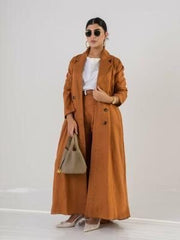 Woman wearing elegant orange blazer abaya made of lightweight linen with classic lapel collar and button details, styled for casual or formal look.