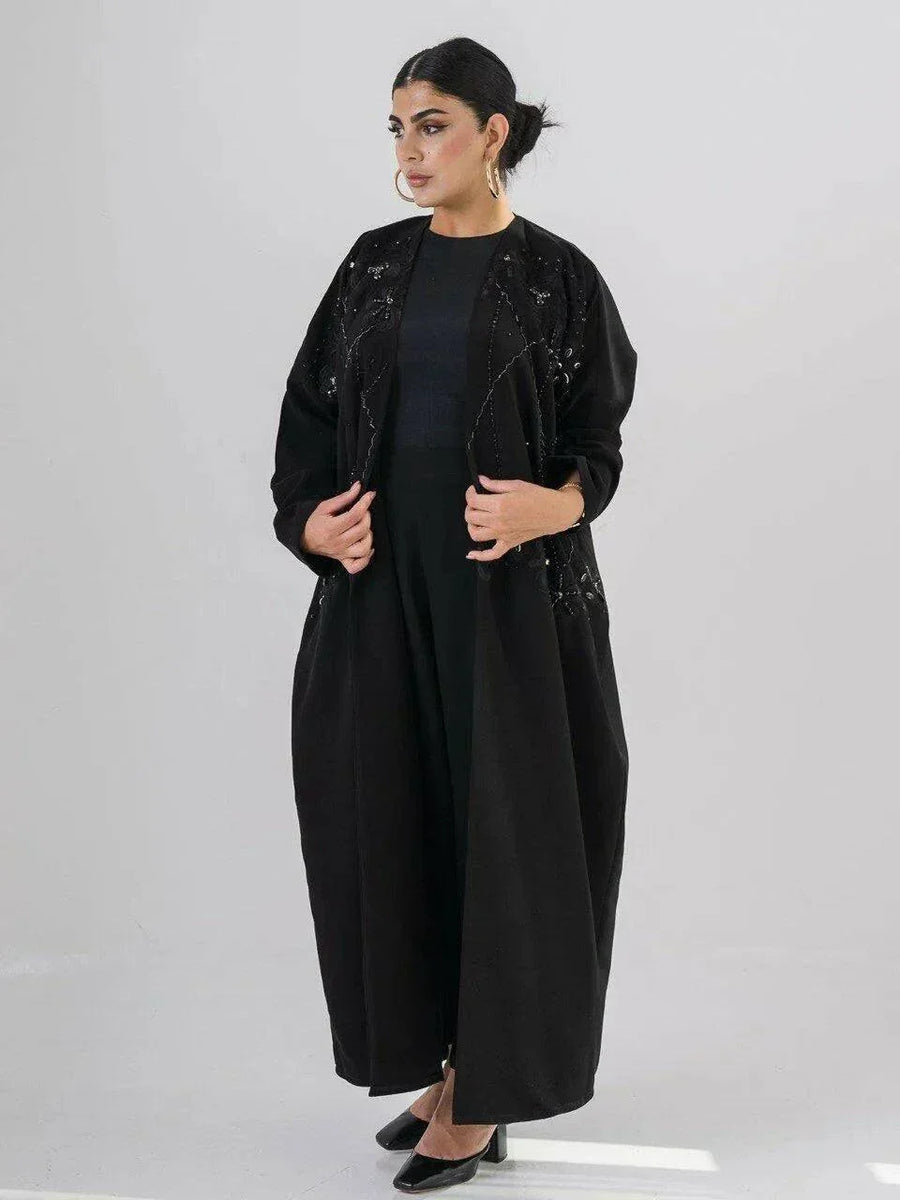 Elegant black abaya with intricate black-on-black embroidery and a soft open front design for modest, sophisticated wear