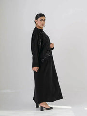 Elegant black abaya with intricate black-on-black embroidery and a soft open front design for modest, sophisticated wear