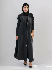 woman wearing luxurious black abaya made from soft cobra silk with elegant fluid drape and lightweight breathable fabric