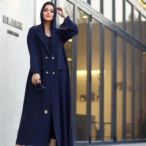 woman wearing navy blue crepe blazer abaya with gold buttons and lapel collar standing outdoors