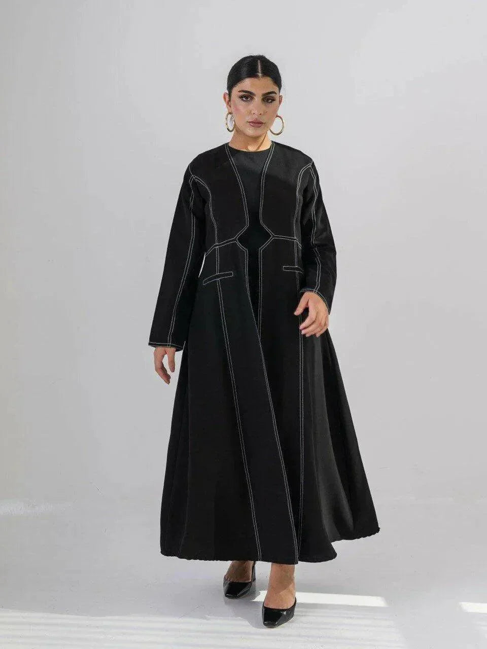 modern black crepe abaya with geometric contrast stitching and full-length silhouette