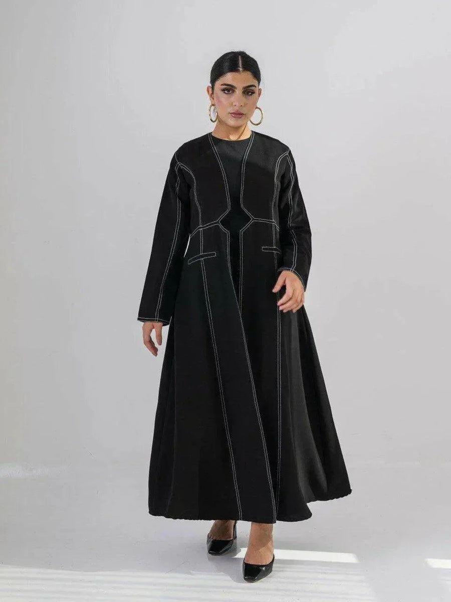 modern black crepe abaya with geometric contrast stitching and full-length silhouette