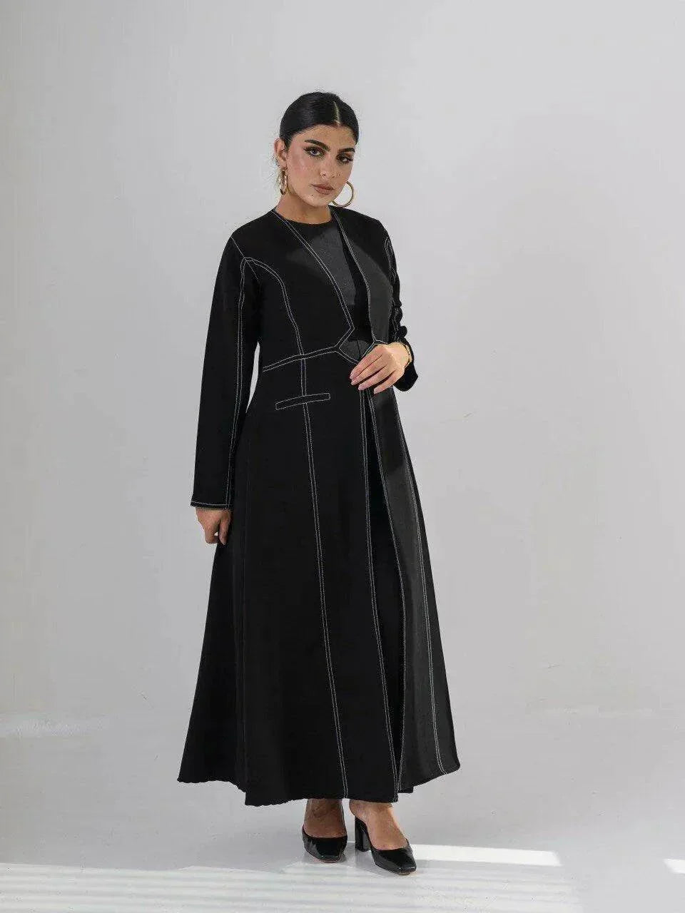 modern black crepe abaya with geometric contrast stitching and full-length silhouette