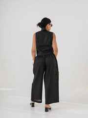 Woman wearing a short black linen vest with buttons, styled with sunglasses and gold accessories - Vest Black Linen