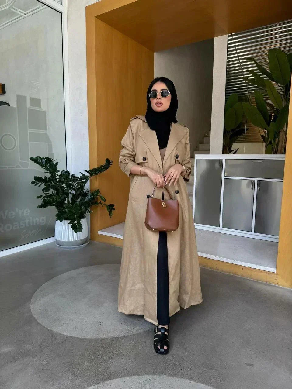 woman wearing tailored sand beige linen blazer coat with brown handbag and black sunglasses indoors - tailored blazer