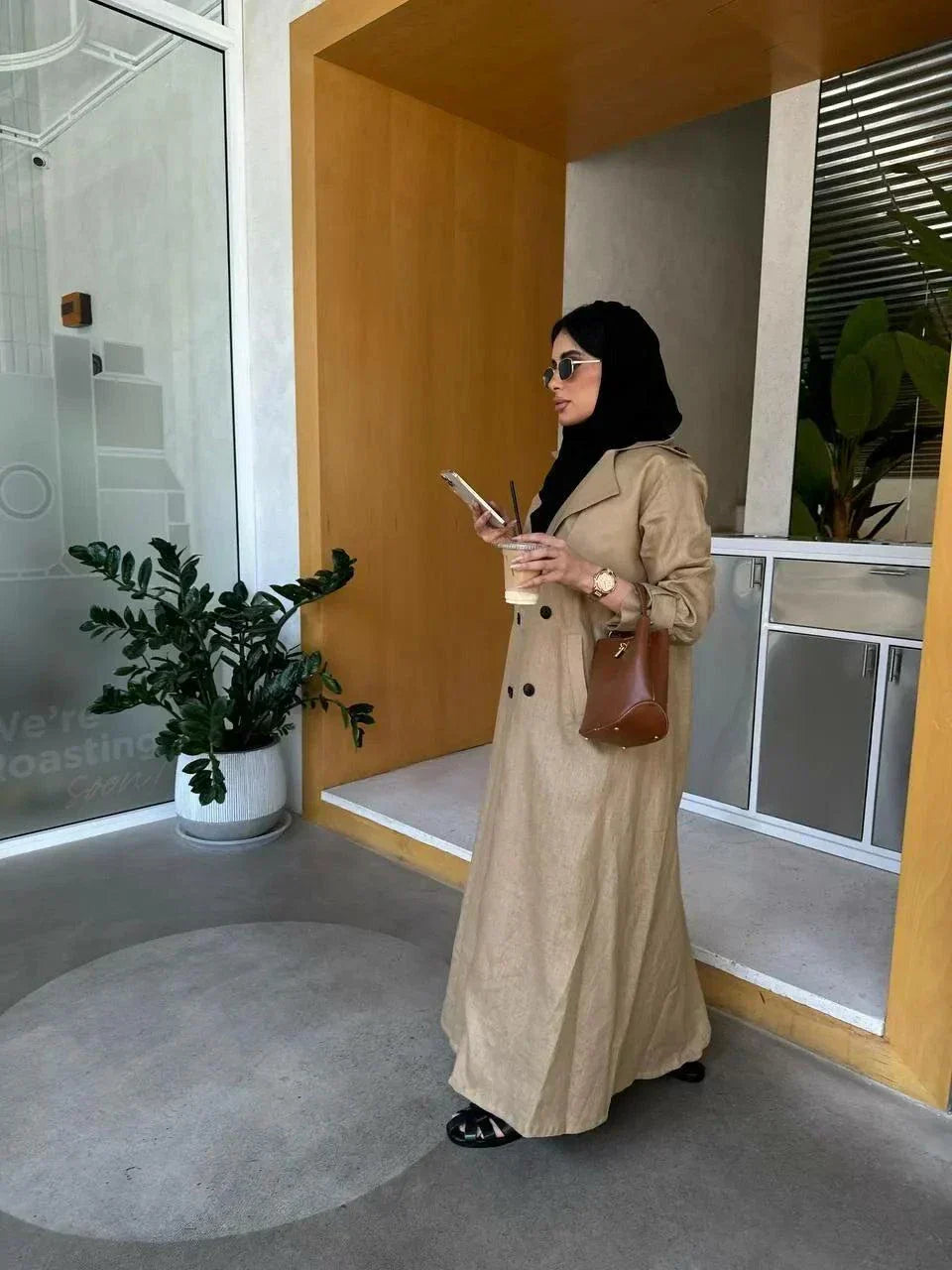 woman wearing tailored sand beige linen blazer coat with brown handbag and black sunglasses indoors - tailored blazer