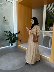 woman wearing tailored sand beige linen blazer coat with brown handbag and black sunglasses indoors - tailored blazer