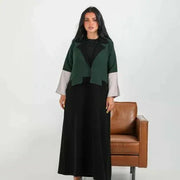 Color-blocked crepe blazer abaya with forest green body, black lapels, and grey sleeve cuffs over a flowy black base.
