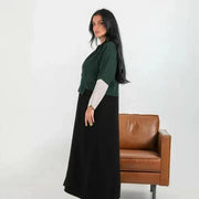 Color-blocked crepe blazer abaya with forest green body, black lapels, and grey sleeve cuffs over a flowy black base.