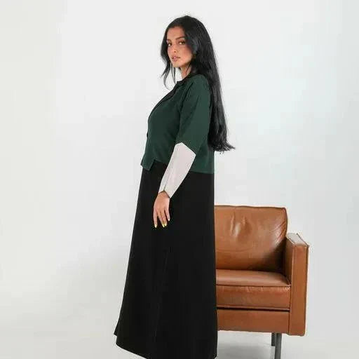 Color-blocked crepe blazer abaya with forest green body, black lapels, and grey sleeve cuffs over a flowy black base.