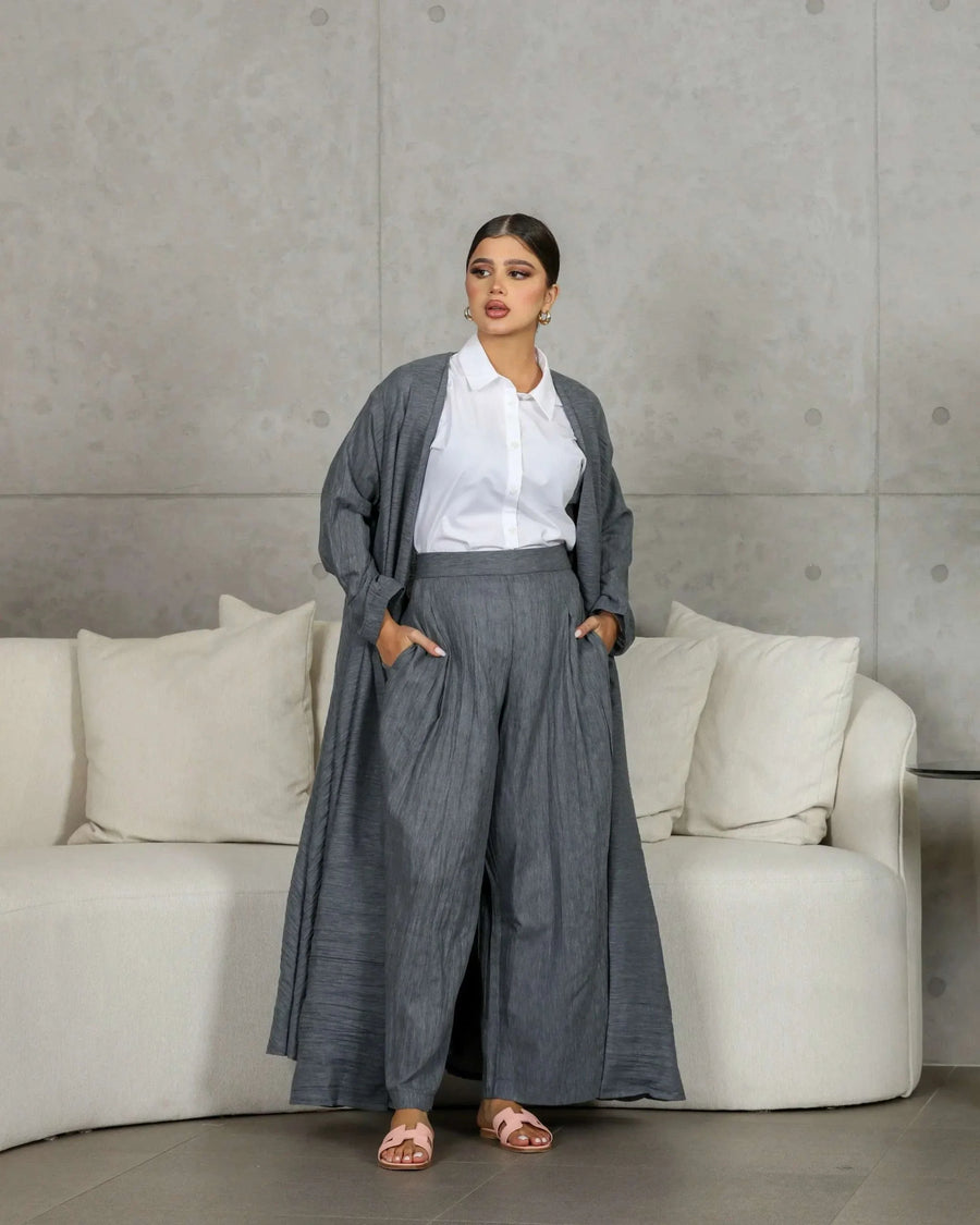 woman wearing gray crumpled linen relaxed-fit outerwear with matching pants and white shirt indoors