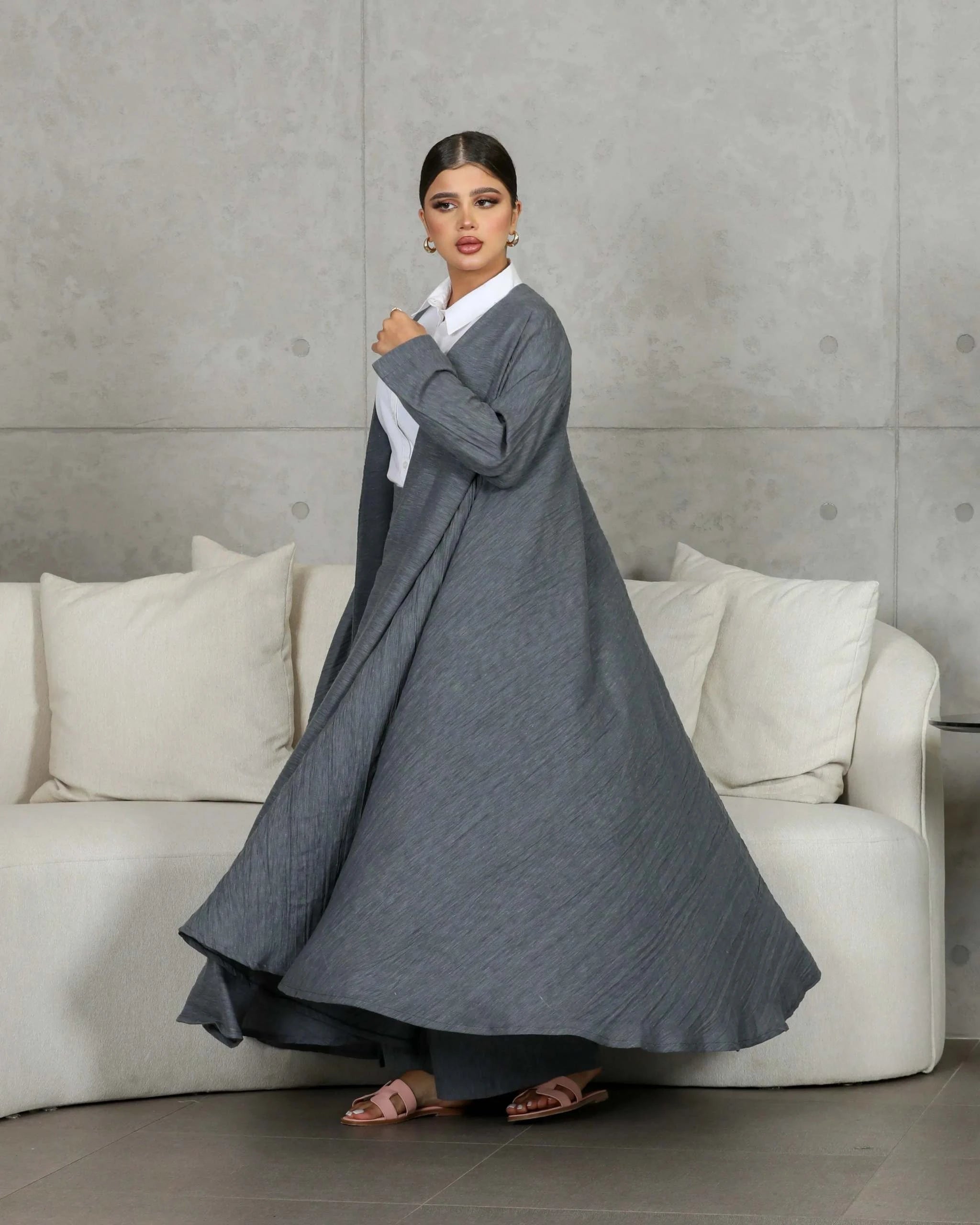 woman wearing gray relaxed-fit outerwear and matching pants with white shirt standing indoors