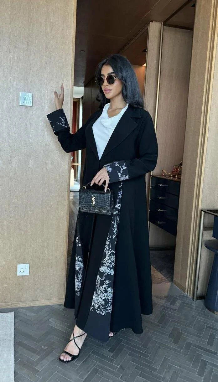 modern black abaya with white crepe fabric accents and minimalist color-block design