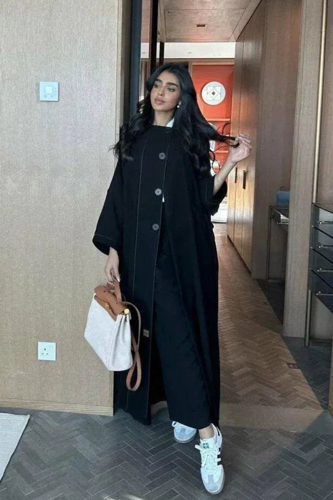 black abaya with button details and straight lines in soft crepe fabric, one-size breathable and modern design