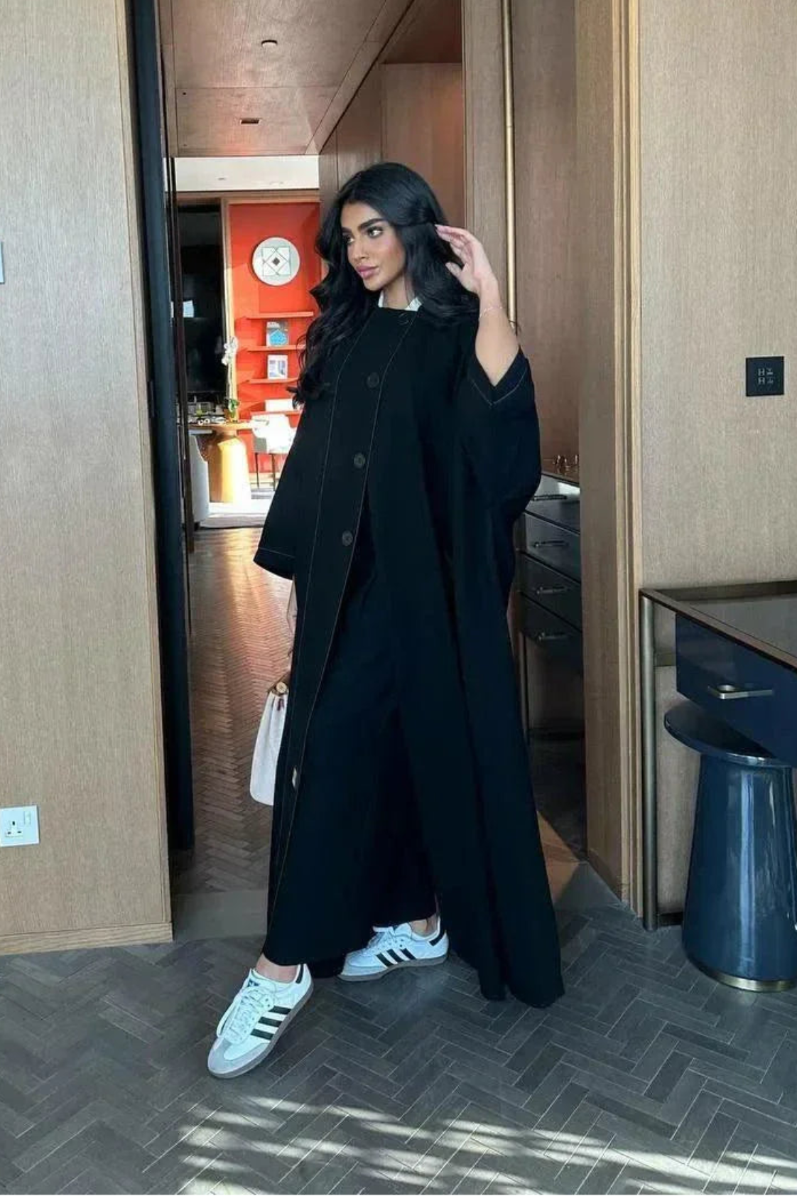 black abaya with button details and straight lines in soft crepe fabric, one-size breathable and modern design