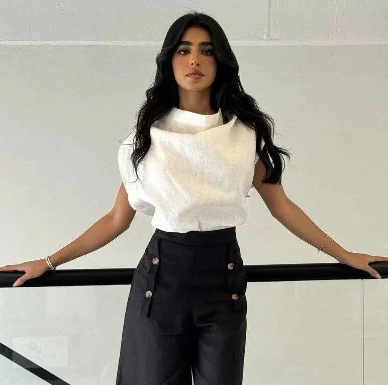 Woman wearing a white linen blouse with a unique collar design paired with high-waisted black pants - Blouse Linen White