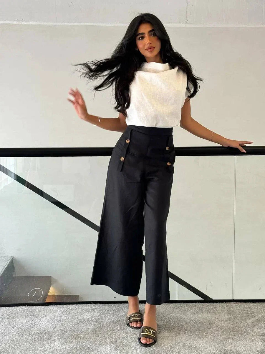 Woman wearing a white linen blouse with a unique collar design paired with high-waisted black pants - Blouse Linen White