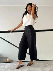 Woman wearing a white linen blouse with a unique collar design paired with high-waisted black pants - Blouse Linen White