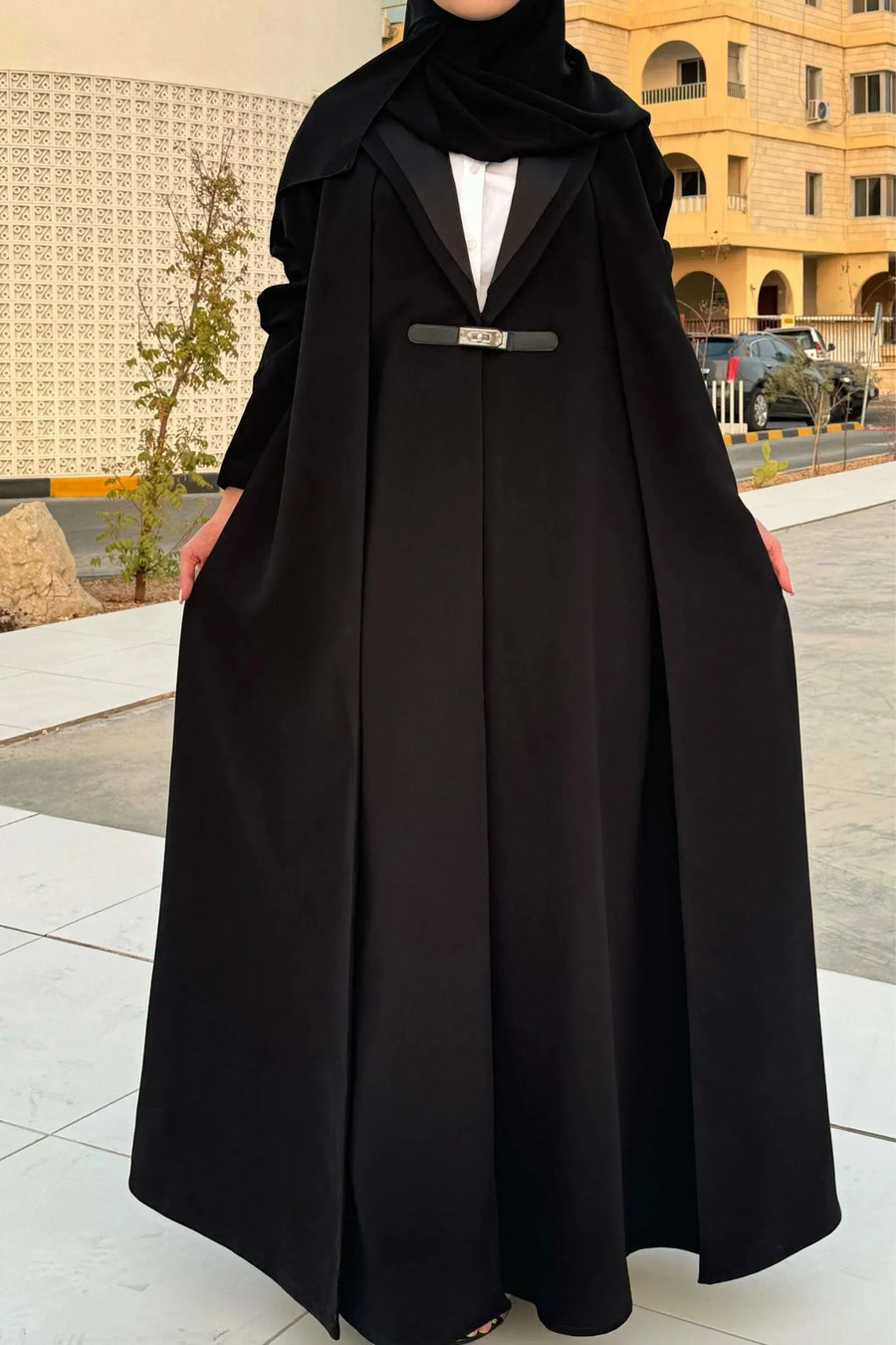 woman wearing chic black crepe and mokado fabric blazer with matching waist belt and sunglasses standing outdoors - chic blazer