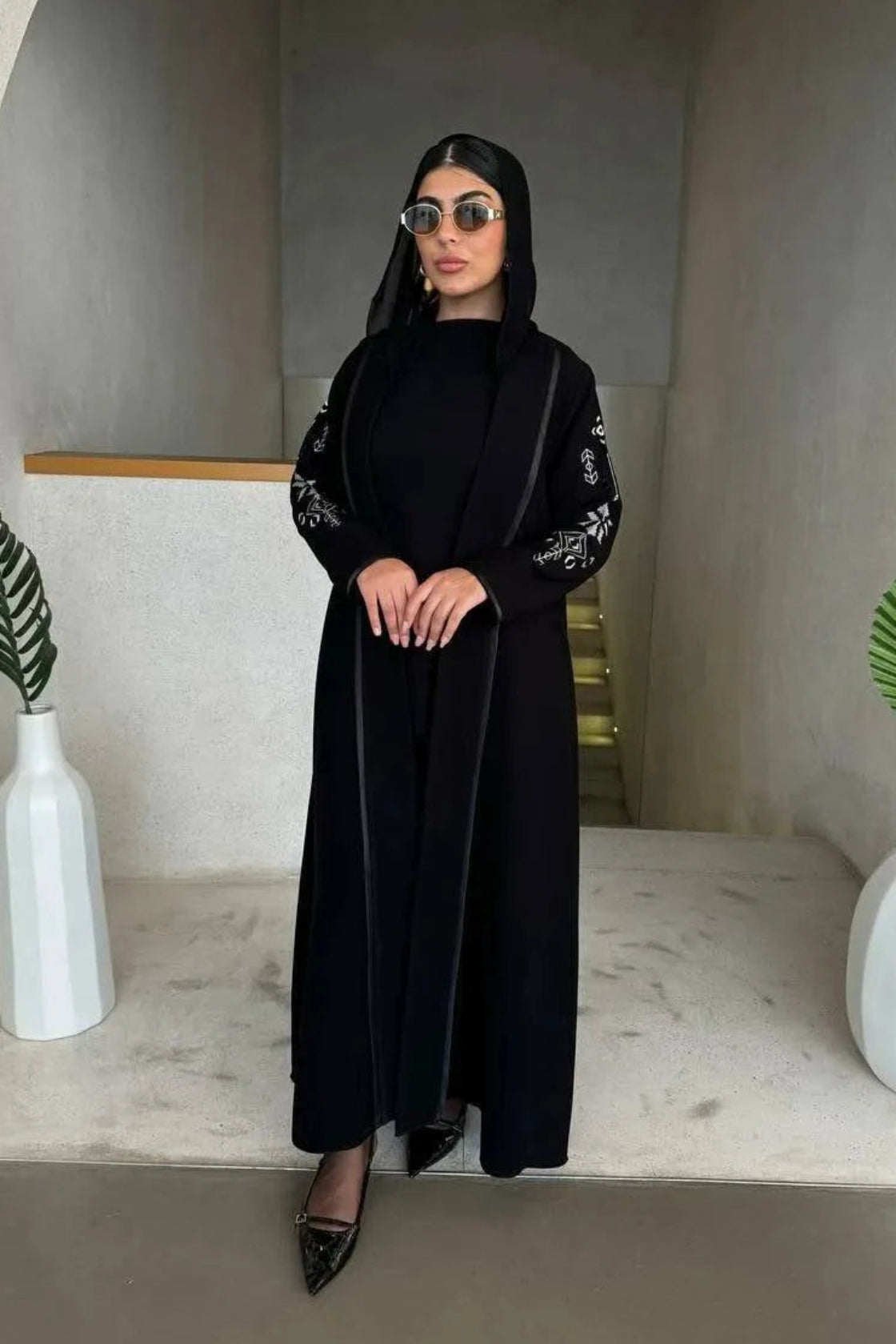timeless black abaya in soft crepe fabric with delicate embroidery on sleeves, elegant and simple silhouette