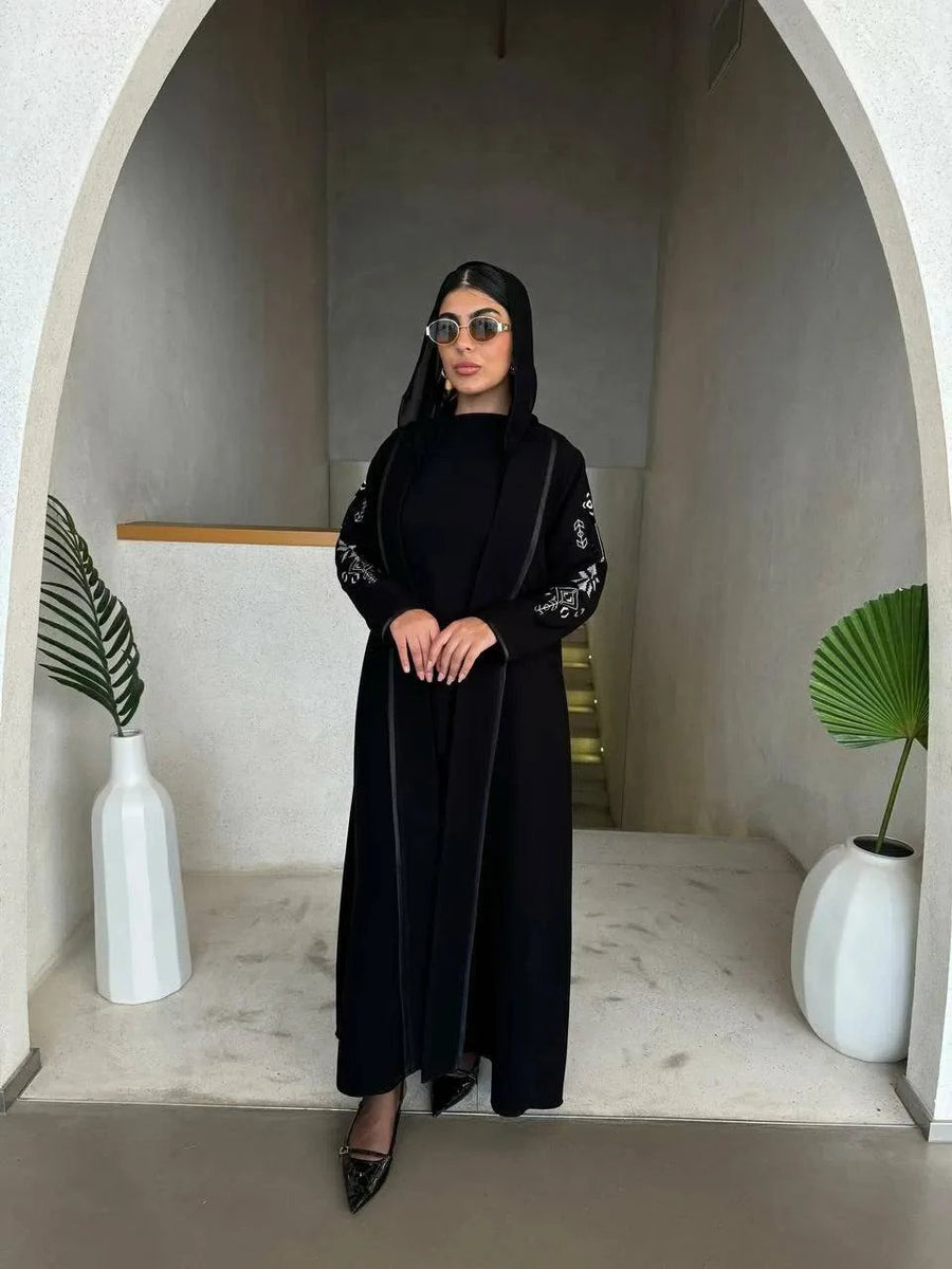 timeless black abaya in soft crepe fabric with delicate embroidery on sleeves, elegant and simple silhouette