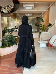 elegant black crepe abaya with subtle back pleats for graceful movement and minimalist front design